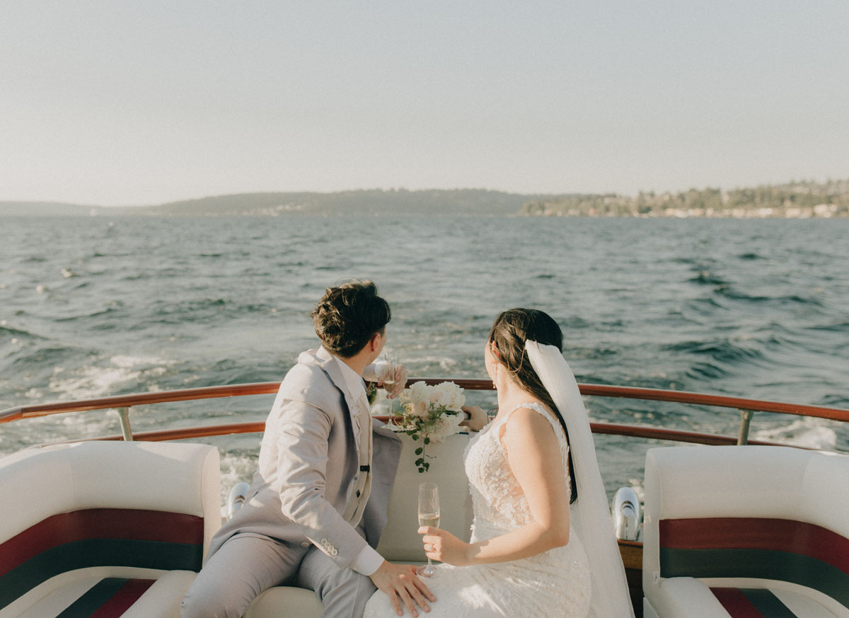 bride and groom looking out into the city from a boat