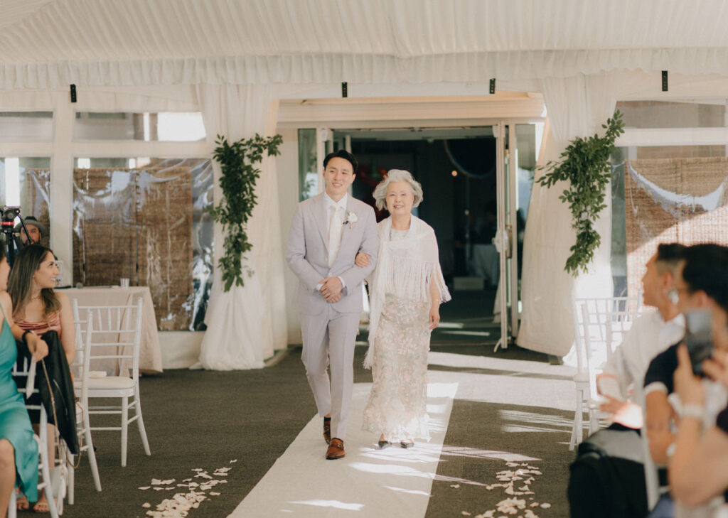 groom walking down with his mother at the woodmark hotel