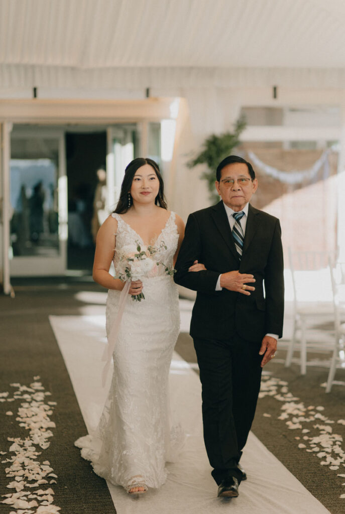 bride walking down with her father at the woodmark hotel