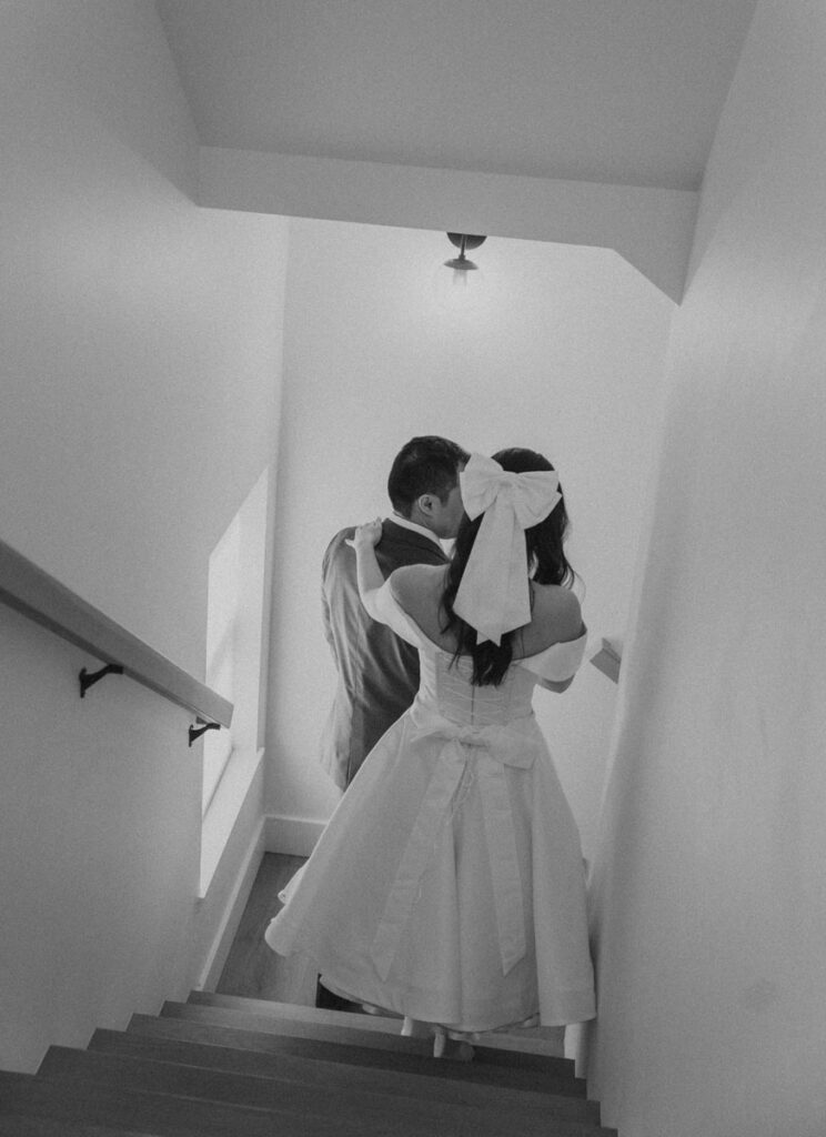 bride and groom walking down the stairs together