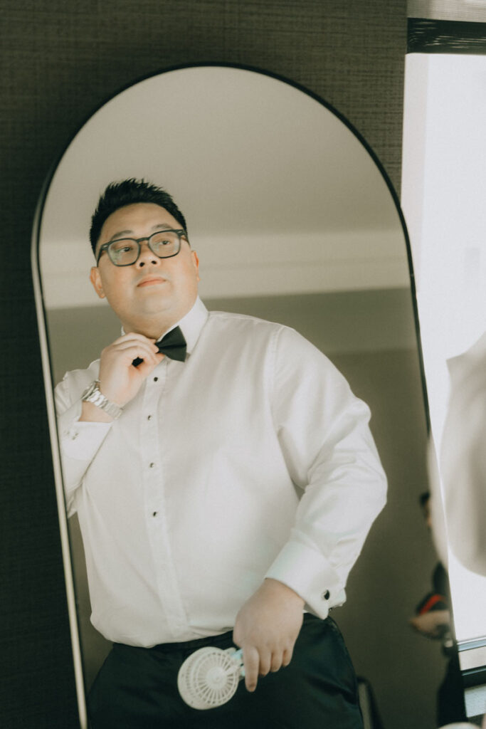 groom looking at himself through mirror