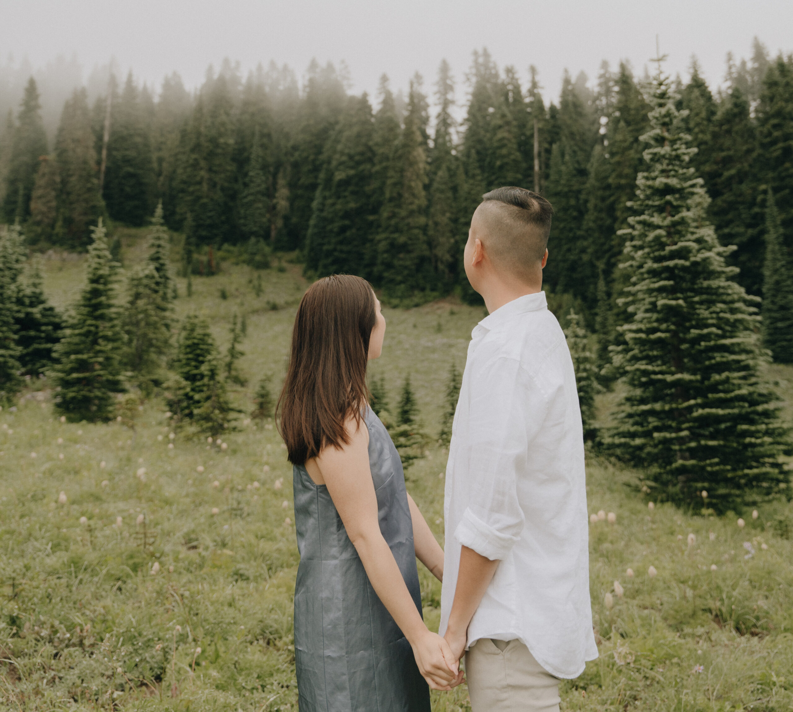 couple looking out into a foggy mount rainier