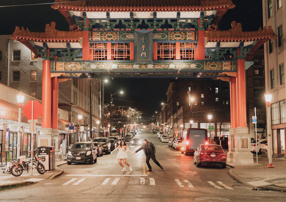 couple walking underneath the iconic chinatown gate